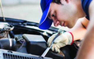 Mechanic working on car engine